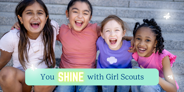 two sisters back to back at a tree