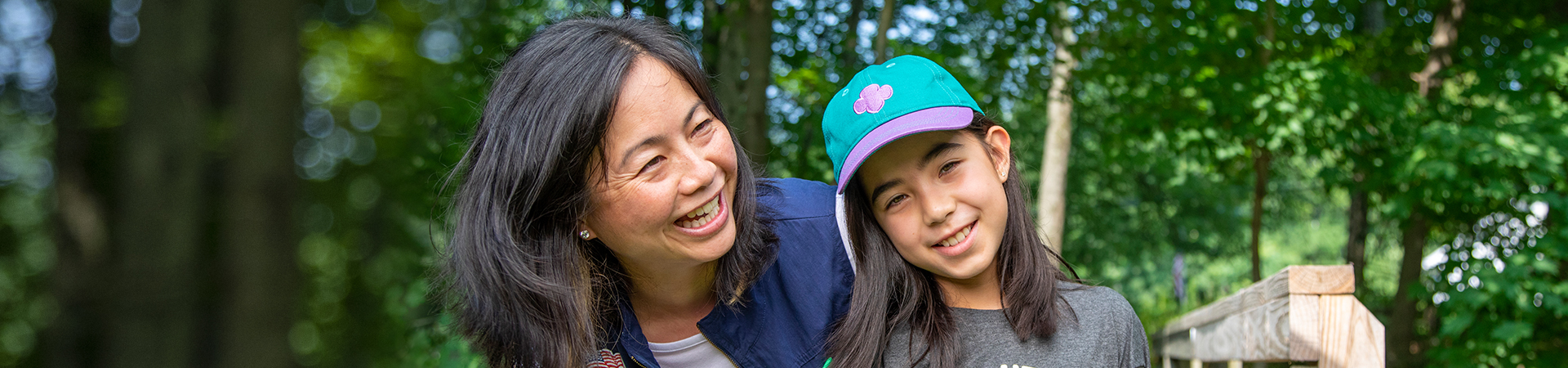  adult woman volunteer in vest outside hiking and smiling 